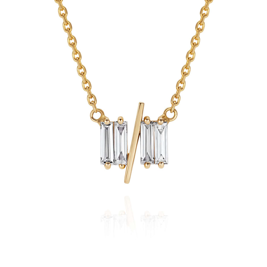 Close up of Sarah May Jewellery 11/11 necklace in yellow gold – featuring a thin yellow gold chain, and pendant featuring 4 long thin diamonds, with a thin diagonal gold bar, to look like the ‘11/11’ symbol.