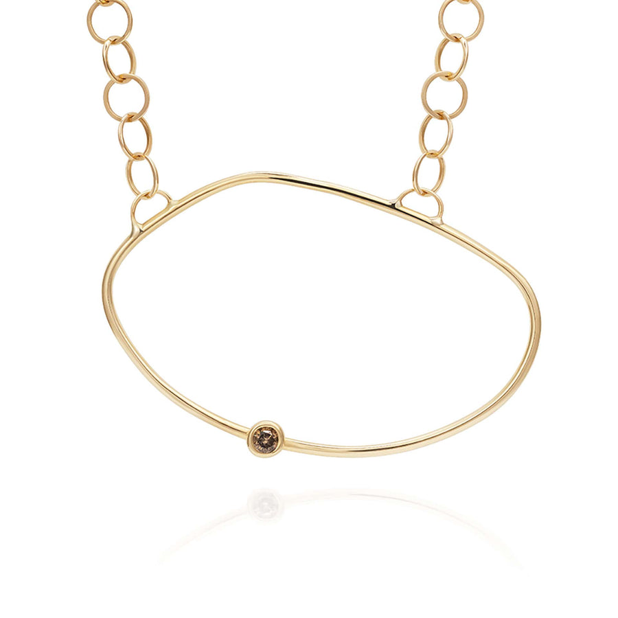 Yellow Gold necklace with an asymmetric oval pendant with a champagne diamond off the centre - inspired by a cell.