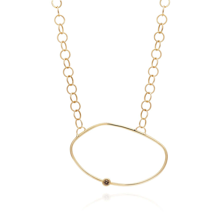 Yellow Gold necklace with an asymmetric oval pendant with a champagne diamond off the centre - inspired by a cell.