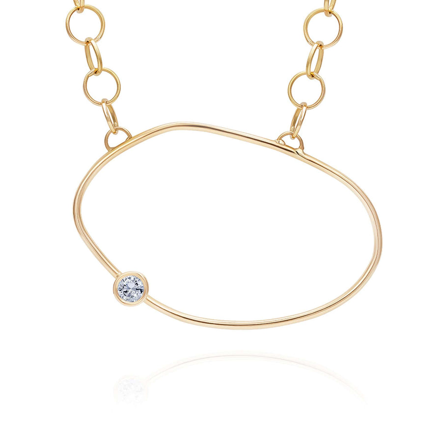 Yellow Gold necklace with an asymmestric oval pendant with a white diamond off the centre - inspired by a cell.